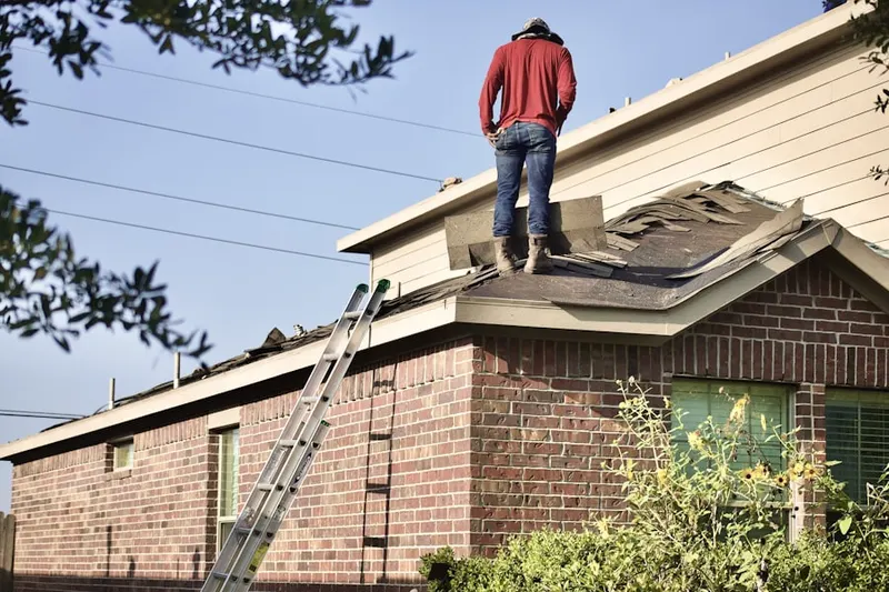 Professional roofer working on a residential roof in Mound House